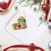Load image into Gallery viewer, Snowflake Christmas greeting card partly inside the festive envelope
